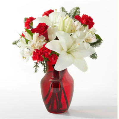 Red and white bouquet in a red glass vase
