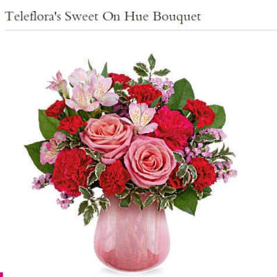 Pink and red mixed bouquet in a pink glass vase
