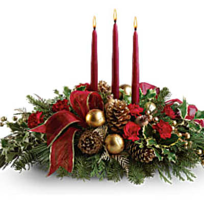 Holiday centerpiece with three red candles and pinecones