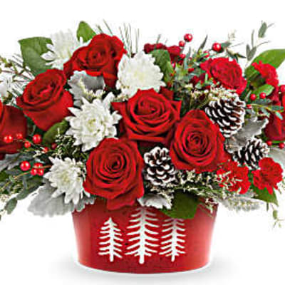 Red roses and white flowers in a red holiday container