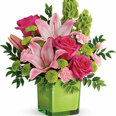 Pink lilies and roses in a green square vase