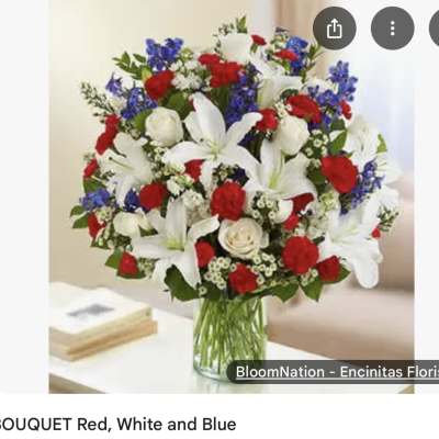 Red, white, and blue bouquet in a clear glass vase