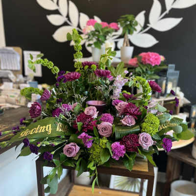 Purple and pink floral arrangement with roses and chrysanthemums