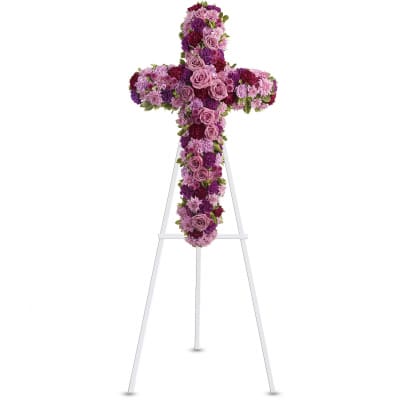 Purple and pink floral cross on a white easel