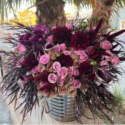 Bouquet of pink and burgundy flowers in a metal vase