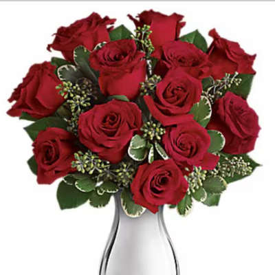 Red roses arranged in a clear glass vase