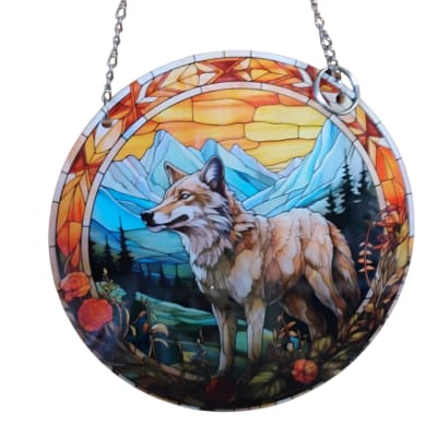 Round hanging suncatcher with a wolf and mountain scene