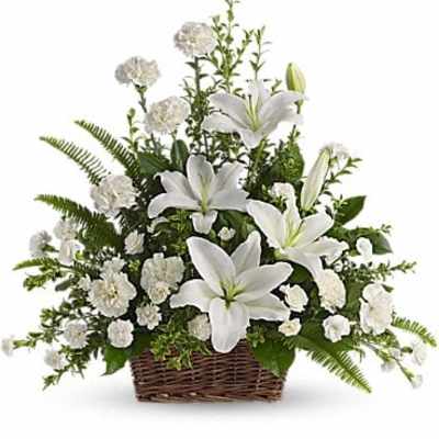 White lilies and carnations in a wicker basket