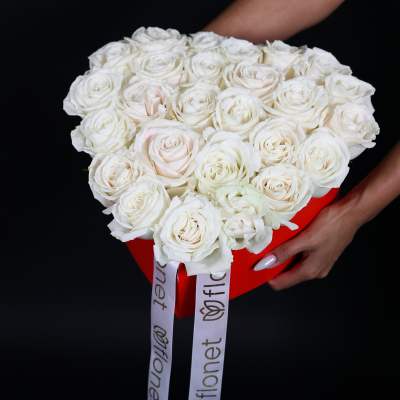 Bouquet of white roses in a red box with long ribbon tails