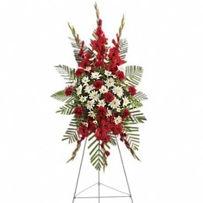 Standing floral spray with red and white flowers on an easel