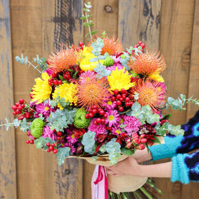 Bright mixed bouquet with yellow, pink, and orange flowers