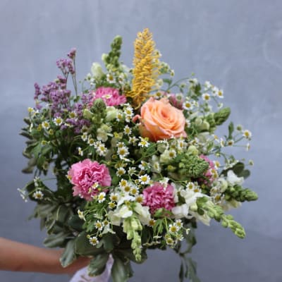 Hand-tied bouquet of mixed pink, peach, white, and yellow flowers