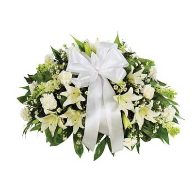 White lily and carnation arrangement with a large white ribbon bow
