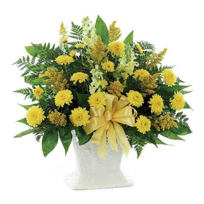 Yellow flower arrangement in a white vase with a yellow ribbon