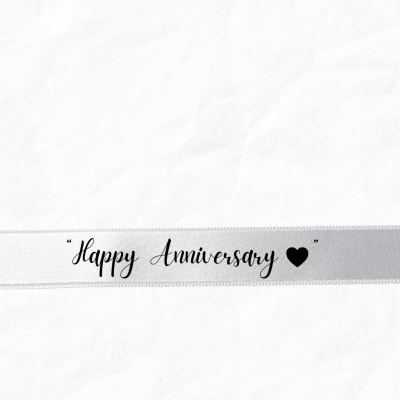 White ribbon with "Happy Anniversary" text and a heart