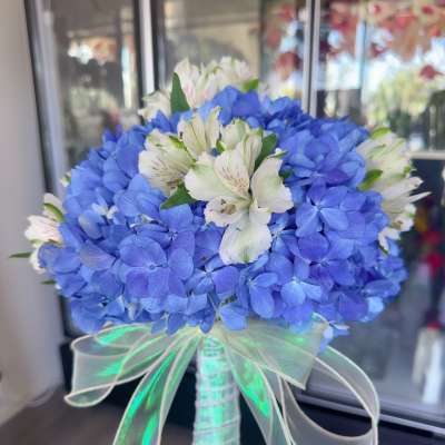 Blue hydrangea bouquet with white alstroemeria and a sheer ribbon handle