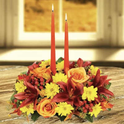 Autumn floral centerpiece with two red taper candles