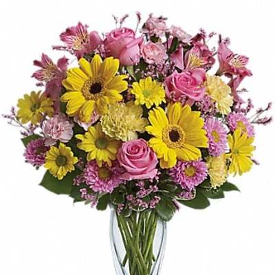 Pink and yellow mixed bouquet in a clear glass vase
