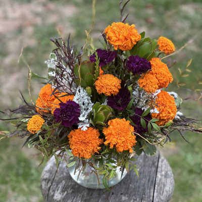 Orange and purple flower arrangement in a vase