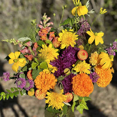 Bright bouquet of yellow, orange, and purple flowers in a vase
