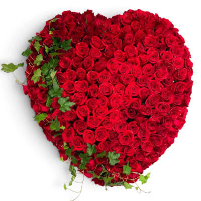 Heart-shaped arrangement of red roses with ivy accents
