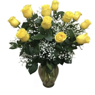 Yellow roses arranged in a glass vase with white baby's breath