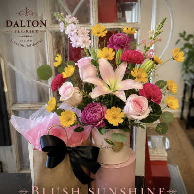 Mixed bouquet with pink roses, lilies, and yellow daisies in a gift box