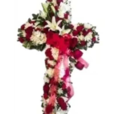 Cross-shaped floral arrangement with red and white flowers on a white background