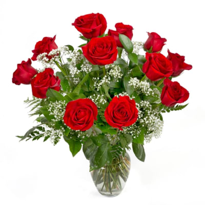 Bouquet of red roses with baby's breath in a clear glass vase