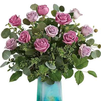 Pink and lavender roses in a blue glass vase