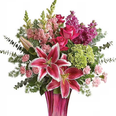 Pink lilies and roses in a tall magenta vase