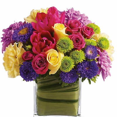 Colorful mixed bouquet in a clear square glass vase