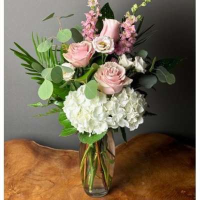 Pink and white floral arrangement in a clear glass vase