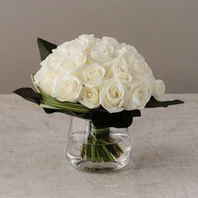 White rose bouquet in a clear glass vase