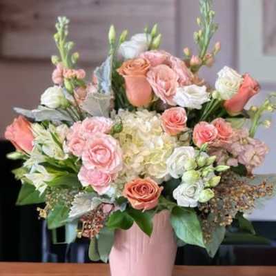 Pink and white rose bouquet in a pink vase