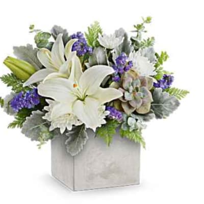 White lilies and purple flowers arranged in a square box