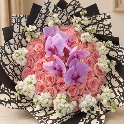 Pink rose bouquet with purple orchids and white accent flowers