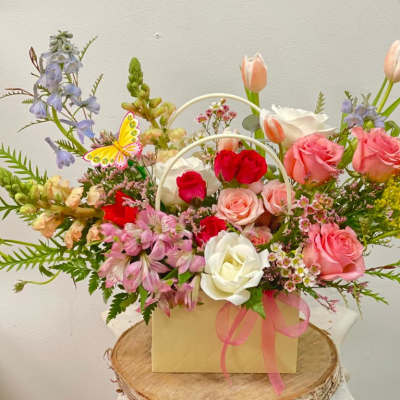 Mixed bouquet of roses, tulips, and alstroemeria in a gift box