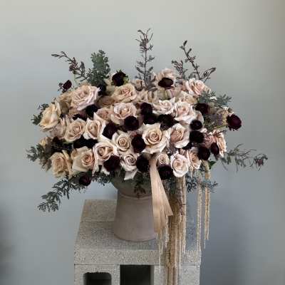 Large bouquet of blush and cream roses in a vase