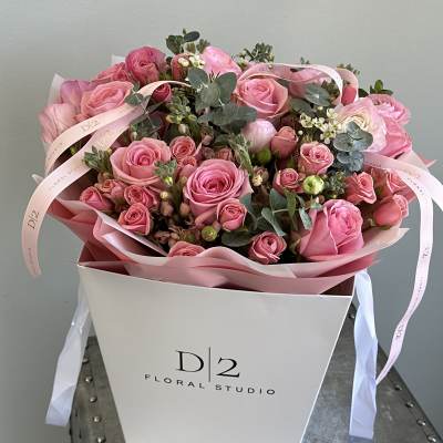 Pink rose bouquet in a white gift box with ribbon