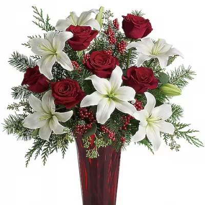 Red roses and white lilies arranged in a tall red vase