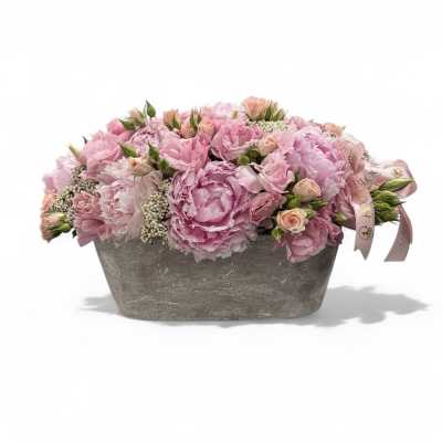 Pink floral arrangement in a gray rectangular container with a ribbon