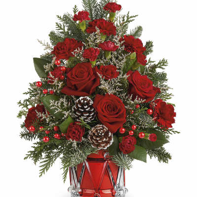 Red roses and carnations in a red glass vase with pinecones