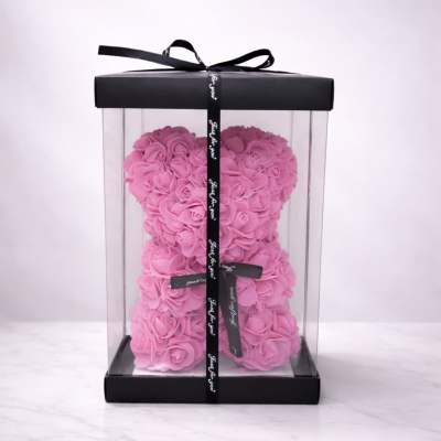 Pink rose teddy bear in a clear gift box with a black ribbon