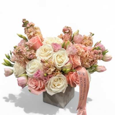 Pink and white rose bouquet in a gray box with a ribbon