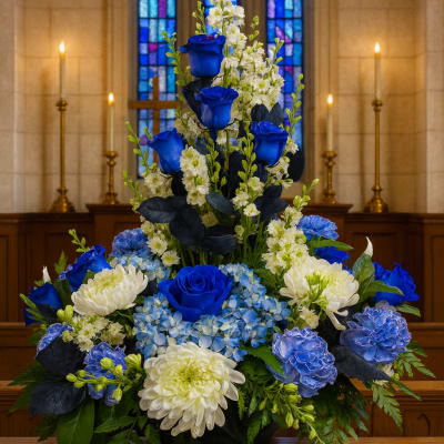 Blue roses and white flowers arranged in a tall church display