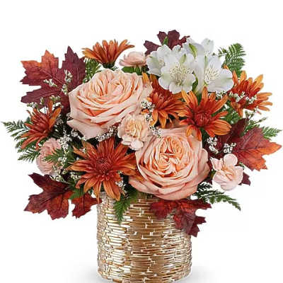 Peach roses and orange daisies in a gold woven vase