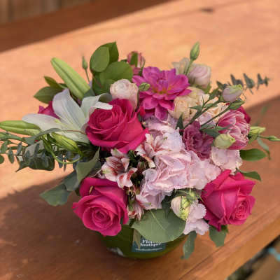 Pink and white mixed bouquet in a green vase
