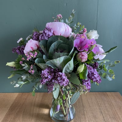Pink and purple mixed bouquet in a clear glass vase