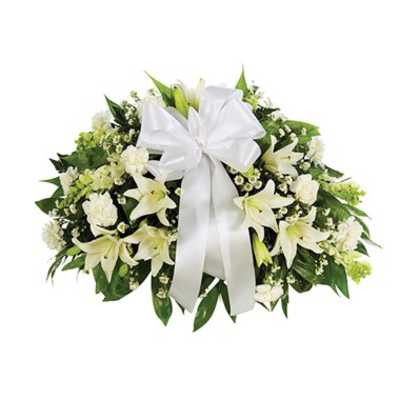 White floral spray with lilies and a large white ribbon